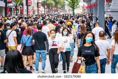 Wuhan China , 1 October 2020 : Crowd Of People Wearing Surgical Face Mask On The 2020 China National Day And First Day Of Golden Week Holidays In Jianghan Pedestrian Road In Wuhan Hubei China