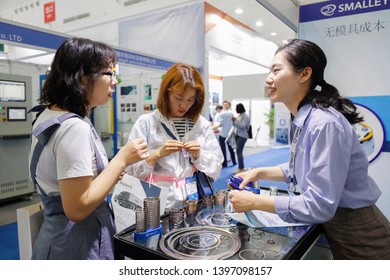 Wuhan, China - May 10, 2019: China International Advanced Automobile Manufacturing Technology Conference, Exhibition Booth Of Smalley Company, Staff Introduces Spring Products To Visitors.