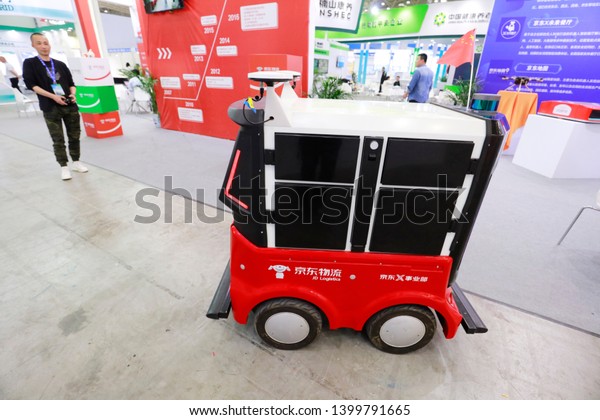 Wuhan, China - May 10, 2019: jd logistics displays\
intelligent logistics of unmanned warehouse intelligent handling\
robot (AGV) at wuhan international e-commerce and \