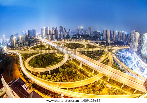 Wuhan, China - May 10, 2019: a busy traffic flow on\
the ma ying road overpass viaduct, next to rows of high-rise\
commercial buildings and residences. China has more than 200\
million cars.