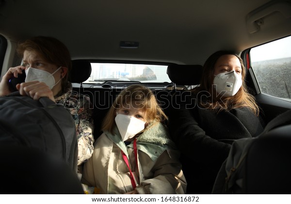 Wuhan,\
Hubei / China - Jan 28 2020: Three US citizens are taking a ride to\
the Tianhe Airport in Wuhan to catch the evacuation flight  charted\
by the US government after the city\
lockdown.