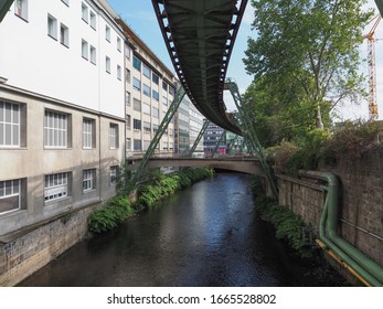 WUPPERTAL, GERMANY - CIRCA AUGUST 2019: Wuppertaler Schwebebahn (meaning Wuppertal Suspension Railway) above River Wupper is the oldest electric elevated railway with hanging cars in the world