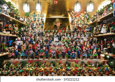 WURZBURG, GERMANY - DECEMBER 2 2013: Shopkeeper Sells Wooden Toys At Christmas Market In Wurzburg On December 2 2013. It Is Considered One Of The Most Atmospheric Christmas In Germany.  