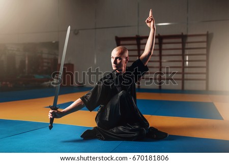 Wushu master training with sword, martial arts