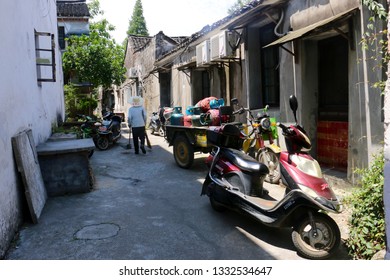 Wuzhen, China - June 8 2017: A Street Cleaner Sweeping An Alley In The Old Town Of Wuzhen