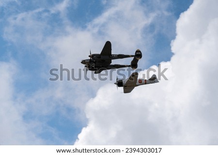 WW2 planes P-38 Lightning and Japanese Zero flying together 