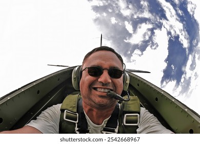 A WWII pilot captures a daring selfie mid-flight, executing precise aerial maneuvers in a classic fighter plane. The vintage cockpit and sky blur, capturing thrill and history in one shot. - Powered by Shutterstock