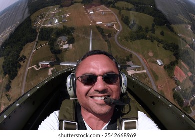 A WWII pilot captures a daring selfie mid-flight, executing precise aerial maneuvers in a classic fighter plane. The vintage cockpit and sky blur, capturing thrill and history in one shot. - Powered by Shutterstock