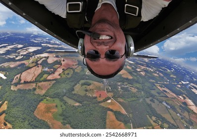 A WWII pilot captures a daring selfie mid-flight, executing precise aerial maneuvers in a classic fighter plane. The vintage cockpit and sky blur, capturing thrill and history in one shot. - Powered by Shutterstock