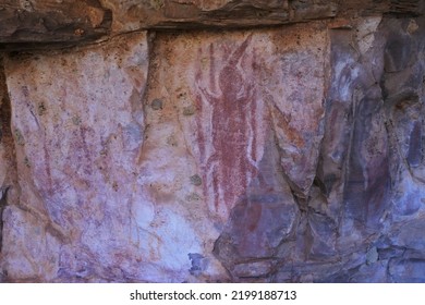 WYNDHAM, WA - AUG 12 2022:Australian Aboriginal Mythology Of A Human Figure Rock Paintings On A Rock Cave In Kimberley Western Australia.