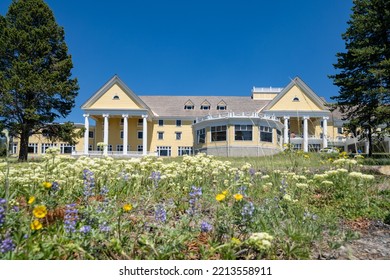 Wyoming, USA - July 19, 2022: Outside The Iconic Lake Yellowstone Hotel, Lodging Inside Of Yellowstone National Park, Wildflowers In Front