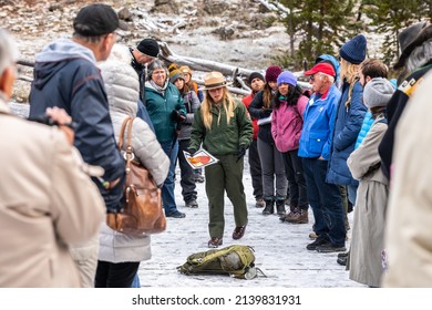 Wyoming, USA - September 30, 2019: Yellowstone Female Officer Giving Travel And Safety Information To Travel Inside Dangerous Area Of National Park Inside Group Of Tourists On Wooden Bridge.