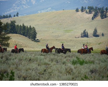 Wyoming, USA--July 2018: Medium Close Up Of Horseback Riders. Horseback Riding Is One Of The Popular Activities For Tourists At Yellowstone National Park.