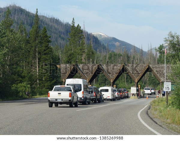 Wyoming,\
USA--July 2018: Vehicles fall in line to pay admission fees at the\
east entrance of Yellowstone National Park.\
