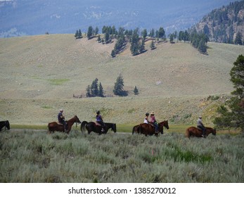 Wyoming, USA--July 2018: Visitors Ride Horses At Yellowstone National Park. Horseback Riding Is One Of The Popular Activities For Tourists.