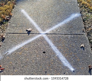 X Marks The Spot On Neighborhood Sidewalk.