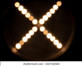 X Shape Chandelier Bokeh Blubs Light Blurred Effect In Dark Room.
