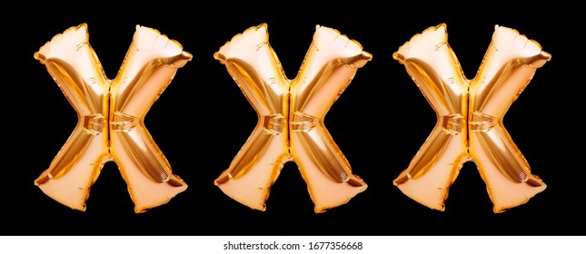 X sign for adult content material. Letters X made of golden inflatable helium balloon on black background. Porn, adult content only. Online porn concept. Sex sites