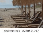 Xanthi Greece May 2022, empty sea side beach relaxing chairs for tourists on sunny day, 