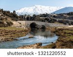 Xanthos river and historic Ottoman bridge at Urluca village near Fethiye town in Turkey.