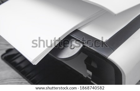 Xerox printer machine and papers on the desk.