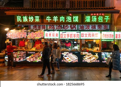 Xian, China - December 29, 2019: Street food night market with crowed pedestrain street in the Muslim Quarter at Xi'an China.