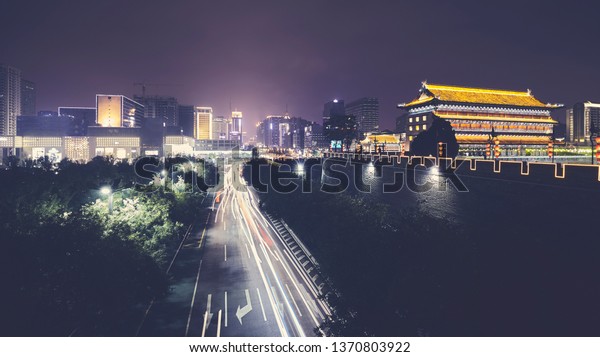 Xian skyline with City Wall at night, color toned\
picture, China.