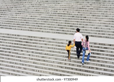 XIAN-MAY 22, 2009. A Family's Way Up On A Staircase On May 22, 2009 In Xian. Since 1979 China's Government Retains A One-child Policy. Families Are Allowed To Have Only One Child Or Risk Steep Fines.