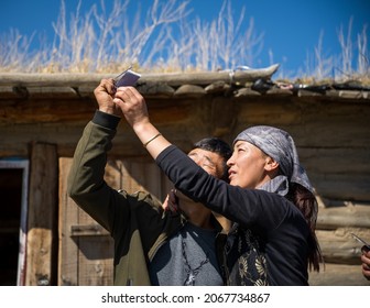 Xinjiang, China - Sep 27 2021: Members Of A Xinjiang Family Are Happily Playing An Instant Camera.