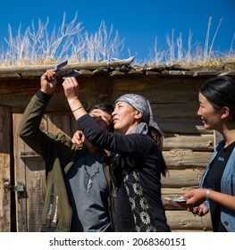 Xinjiang, China - Sep 27 2021: Members Of A Xinjiang Family Are Happily Playing An Instant Camera.