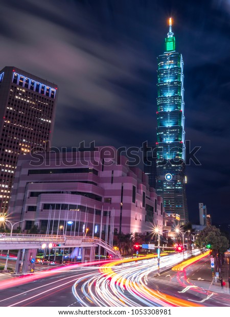 Xinyi Road, Taipei, Taiwan - March 1, 2018 : Night\
light Cityscape of Taipei 101 skyscraper with light trial in the\
street
