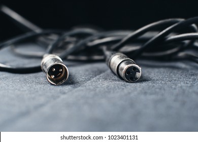 XLR, connector with wires on a dark fabric background in the Studio