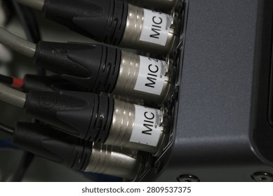 XLR microphone cables on the back of the digital mixer.