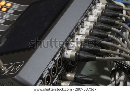 XLR microphone cables on the back of the digital mixer.
