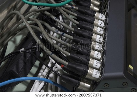 XLR microphone cables on the back of the digital mixer.