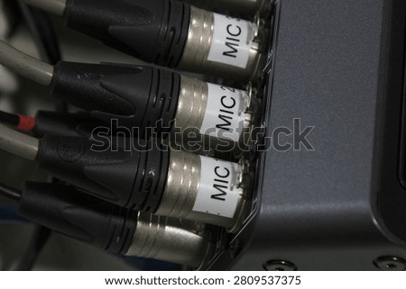 XLR microphone cables on the back of the digital mixer.