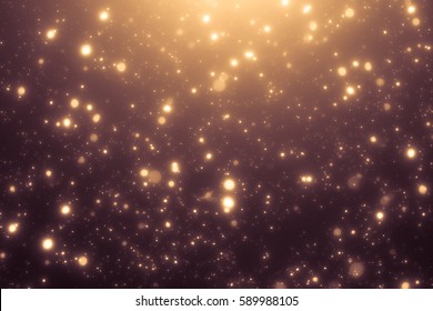 Xmas Golden abstract sparkles or glitter lights. Festive gold background. Defocused circles bokeh or particles. Template for design. 2020