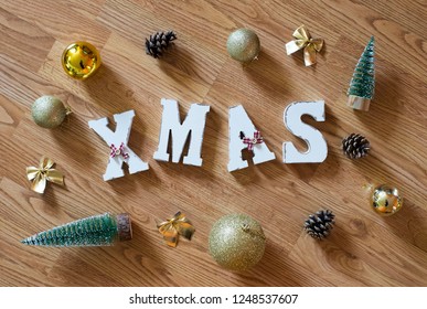 Xmas Letters On Wooden Floor With Christmas Ornaments Nad Pinecones. Christmas Tree Decoration Mood. New Year Concept.
