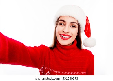 Xmas Selfie Of Pretty Brunette Wearing Red Sweater And Santa Hat