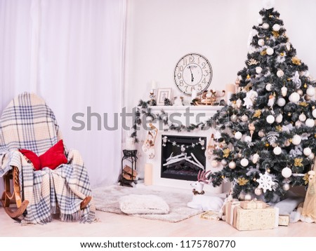 Xmas Tree and Fireplace with armchair, gifts, clocks and pillows. Christmas stocking over fireplace, New Year's card scenery. Snowman and stars. New Year concept