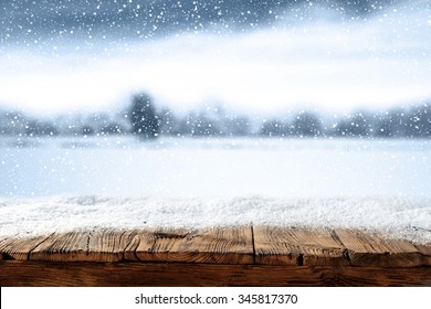 Xmas Winter Blurred Background In Blue Color And Shabby Wooden Table Place 