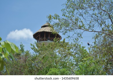 Xplor, México - 7 June 2019: Man In The Distance Enjoying A Zipline Ride Through The Caribbean Jungle.