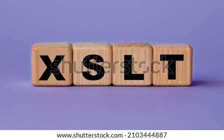 XSLT (Extensible Stylesheet Language Transformations) - acronym on wooden cubes on a lilac background