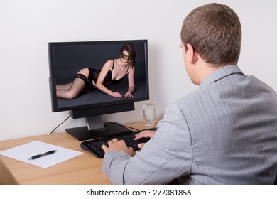 xxx concept - man looking adult content on computer in bright office