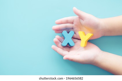XY chromosome word on baby boy hands.kid child children gender.DNA, biotechnology, Human, XY Chromosome concept.Male Heterogametic.Fertility, ivf, sperm cell.Science for kids image background.Medical.