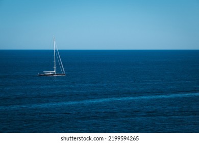 Yacht In The Blue Sea Background, Small Sailboat Adventure, Seascape, Boat Travel Through The Deep Ocean Horizon.