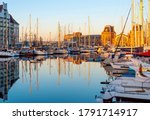The yacht harbor of Oostende (Ostend) with train station at sunset, Belgium.