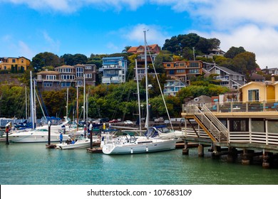 Yacht harbor and waterfront in Tiburon, CA.  View from the water of boats and hillside homes.  Tiburon is an affluent suburb of San Francisco on the bay.