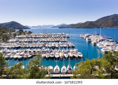 Yacht Marina. Footage of many luxury boats and yachts in the harbor. Beautiful forested mountain landscape in the background. Gocek Marina, Mediterranean coast, Fethiye TURKEY