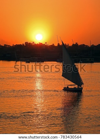 Similar – Silhouette einer ägyptischen Stadt mit Segelboot im Vordergrund und pastellrosa-lila farbenem Himmel, Sonnenuntergangsstimmung